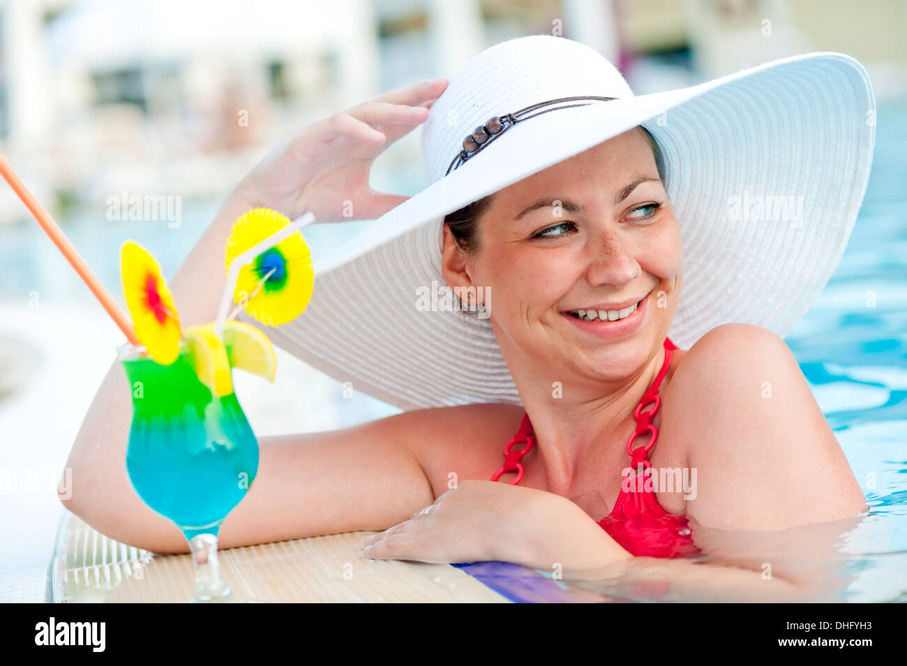 beautiful woman in a hat and cocktail Stock Photo