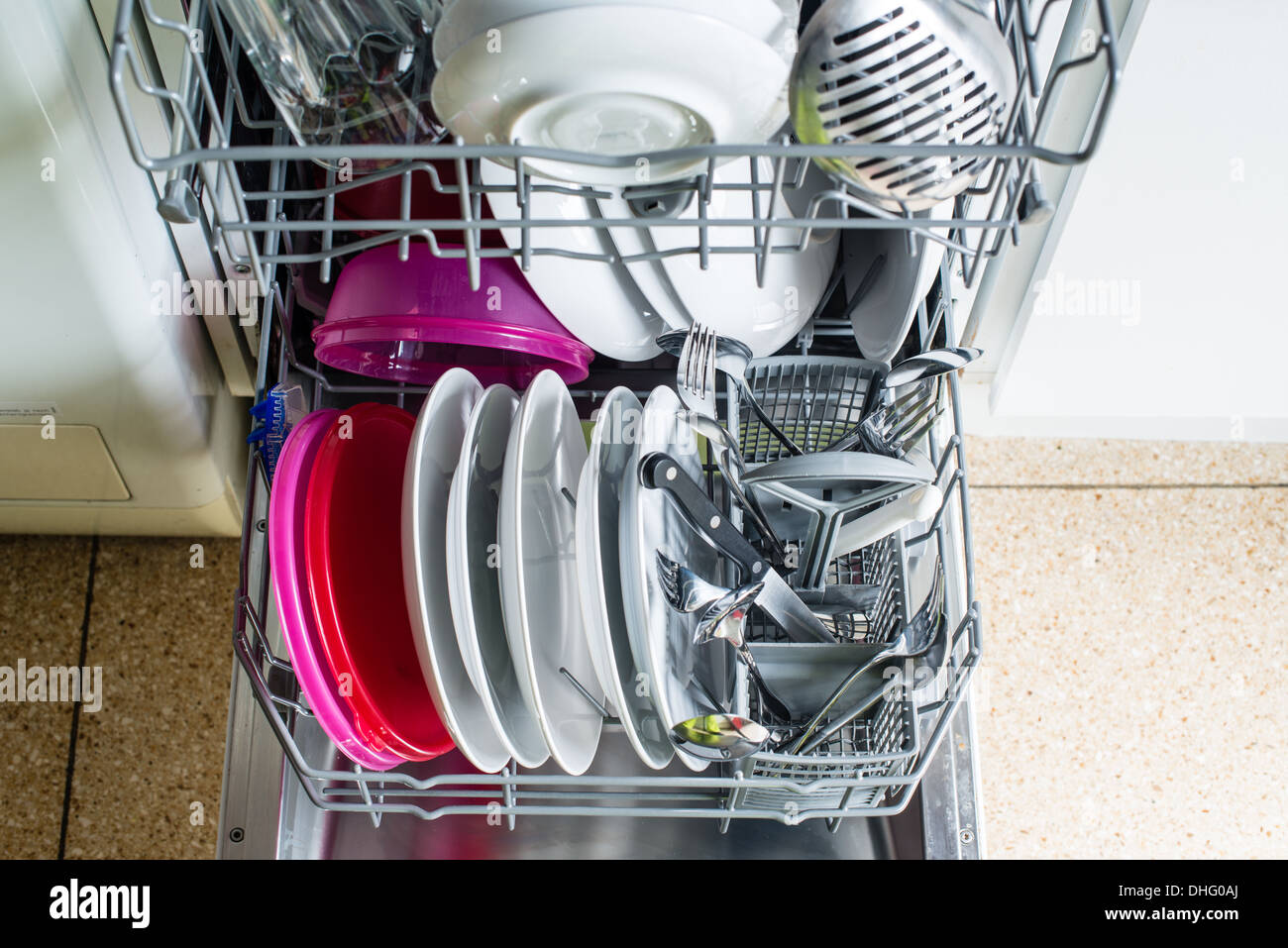 Dishwasher after cleaning process with plates, cups, glasses, cutlery
