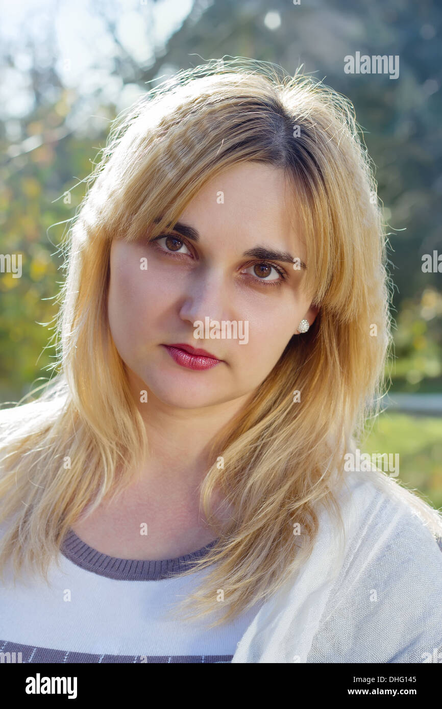 Portrait of a young woman in autumn park Stock Photo - Alamy