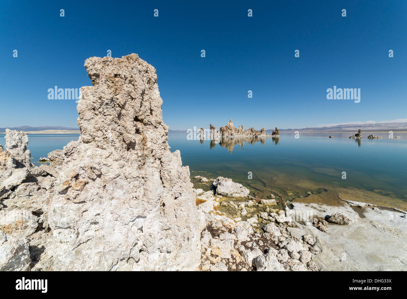 View of tufa at Mono Lake in California, with Sierra Nevada mountains in background. Stock Photo