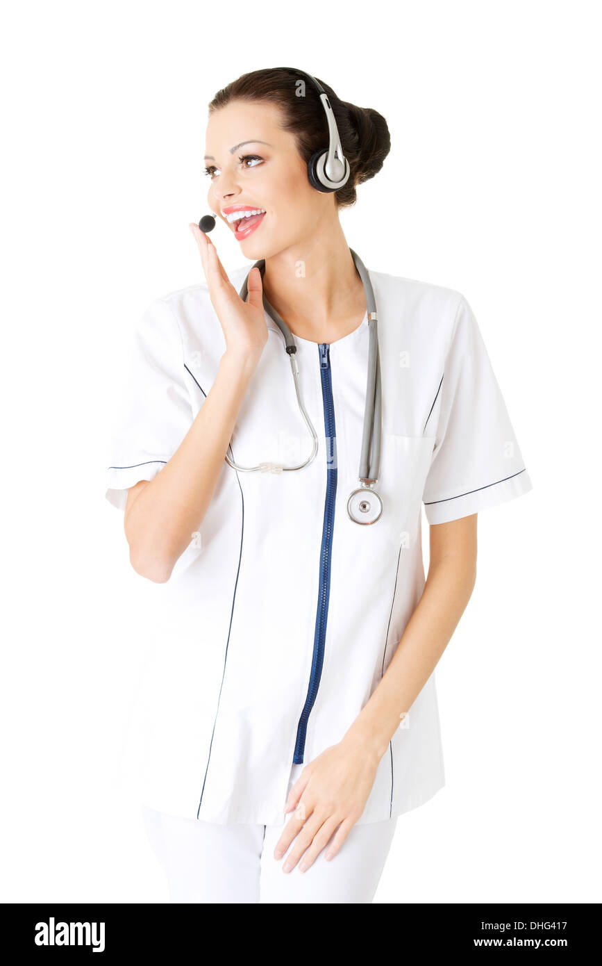 Young attractive nurde with stethoscope and headphones and microphone.  Isolated on white Stock Photo - Alamy