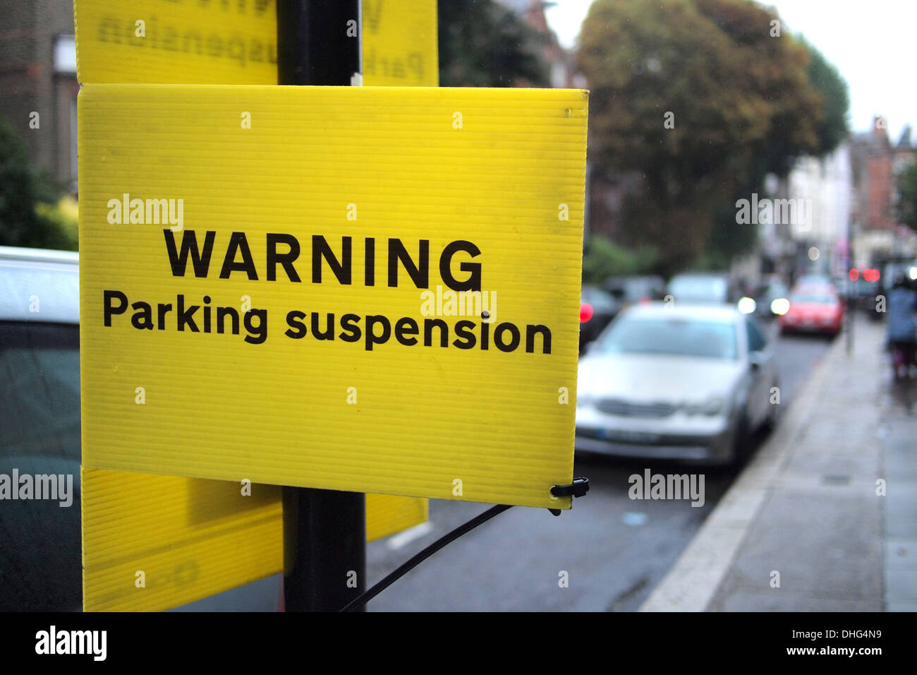WARNING Parking Suspended sign on London street road, England UK Stock Photo