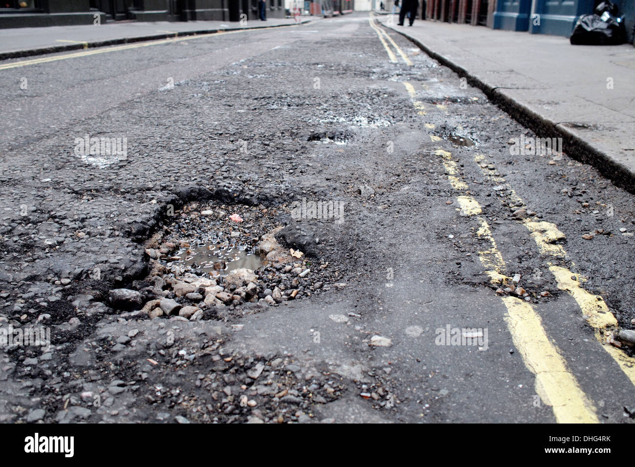 Pothole road damage on London road street UK Stock Photo