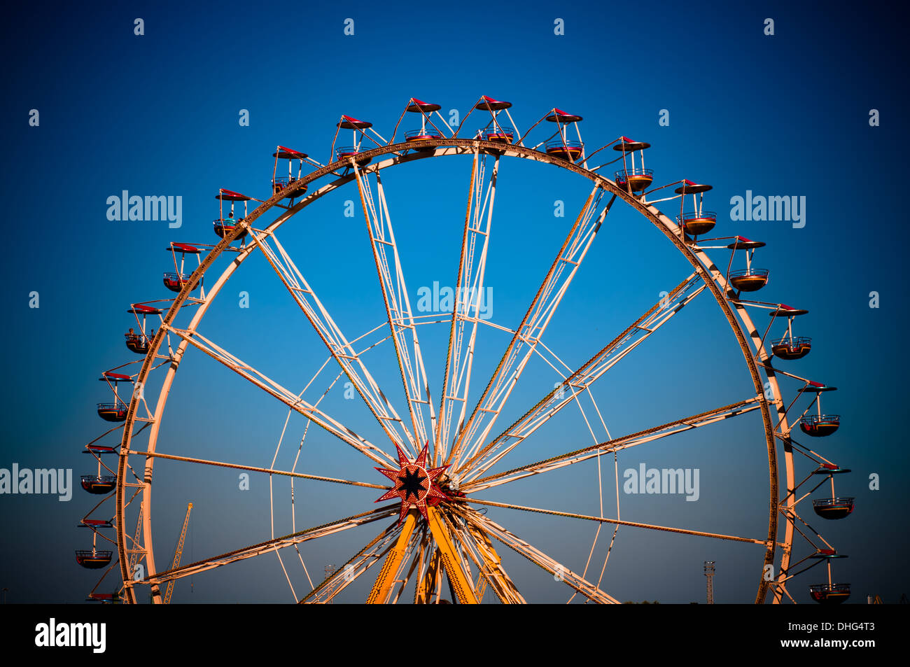 big wheel with multicolored cabins in amusement park Stock Photo - Alamy