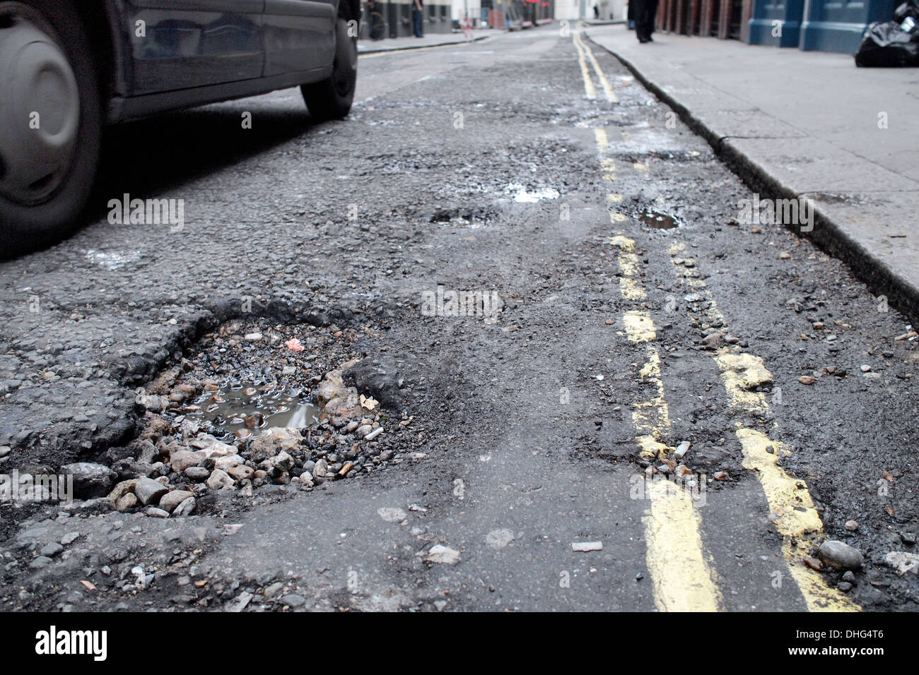 Pothole road damage on London road street driving Stock Photo