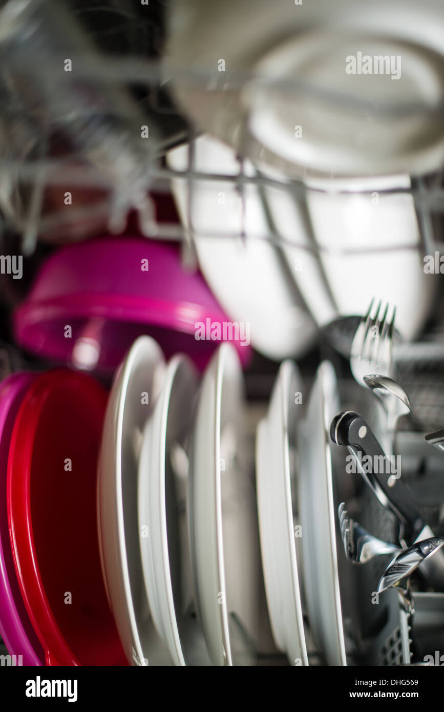 Dishwasher after cleaning process with plates, cups, glasses, cutlery