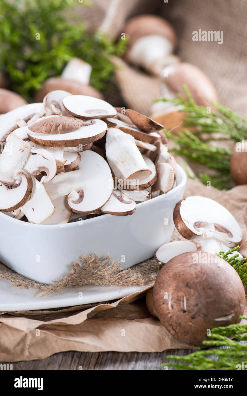 Portion of sliced Mushrooms on wooden background Stock Photo