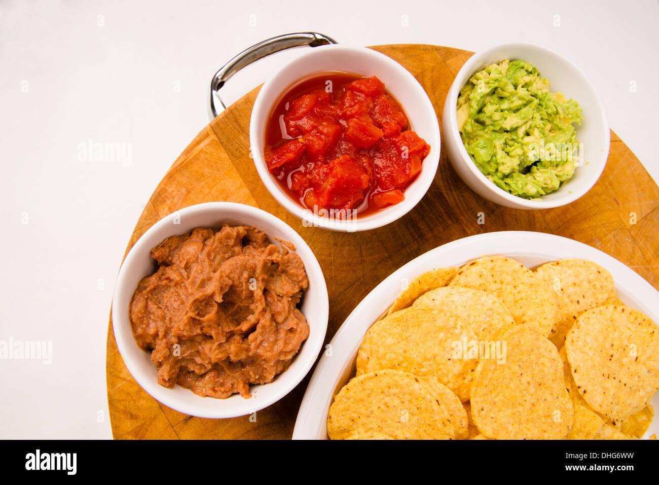 Food Appetizers Chips and Salsa Refried Beans Guacamole on Wood Cutting
