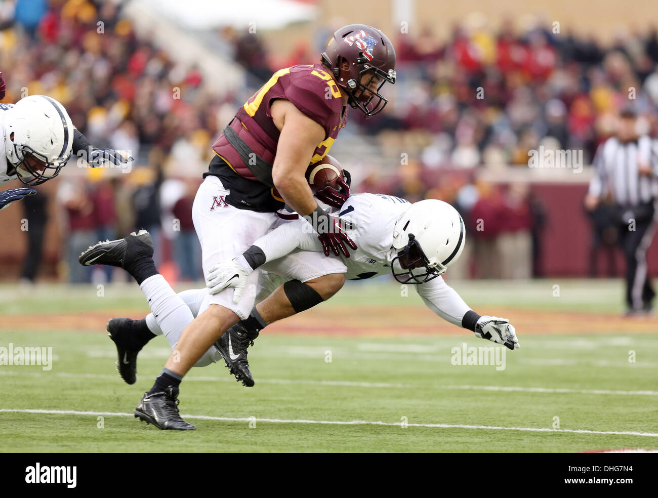 Minneapolis, MN, USA. 9th Nov, 2013. November 9, 2013: Minnesota Gophers fullback Mike Henry (30) is tackled by Penn State safety Malcolm Willis (1) during the NCAA football game between the University of Minnesota Gophers and the Penn State Nittany Lions at TCF Bank Stadium in Minneapolis, Minnesota. Minnesota defeated Penn State 24 - 10. © csm/Alamy Live News Stock Photo