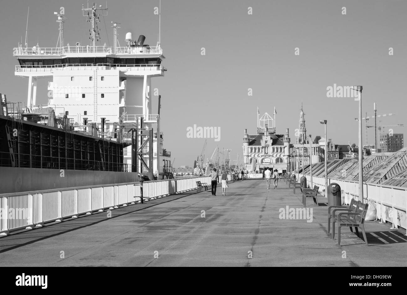 ANTWERP, BELGIUM - SEPTEMBER 5: Promenade and big cargo boat on September 5, 2013 in Antwerp, Belgium Stock Photo