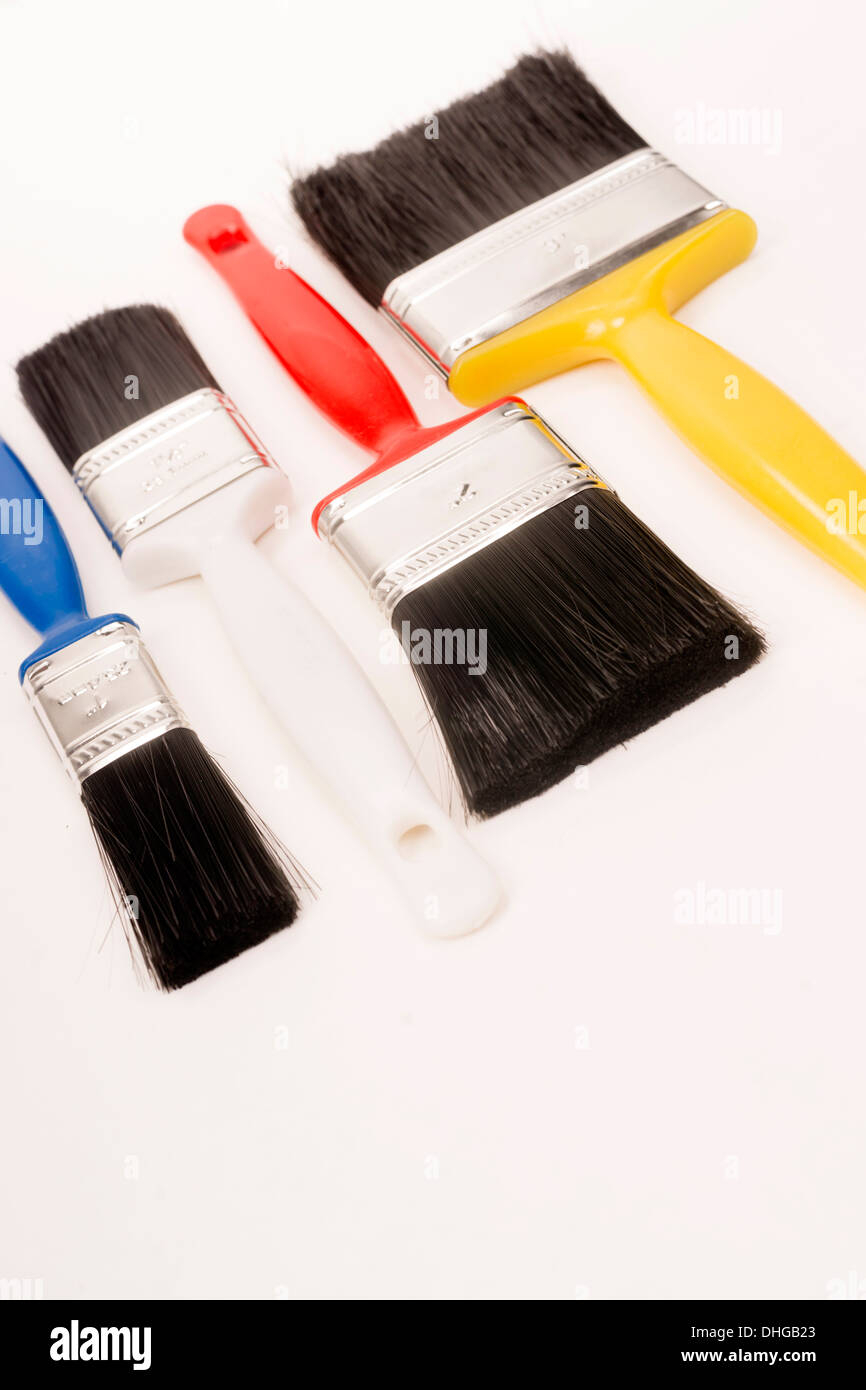 Four Assorted Size Paint Brushes with Multi Color Handles Stock Photo