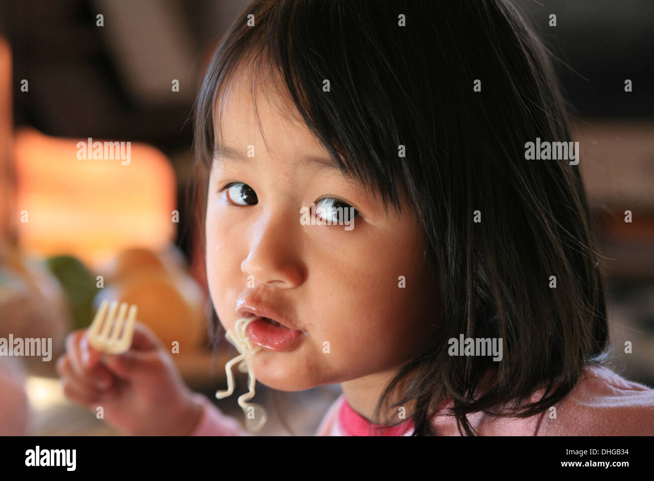 close up of hungry child eating pasta Stock Photo