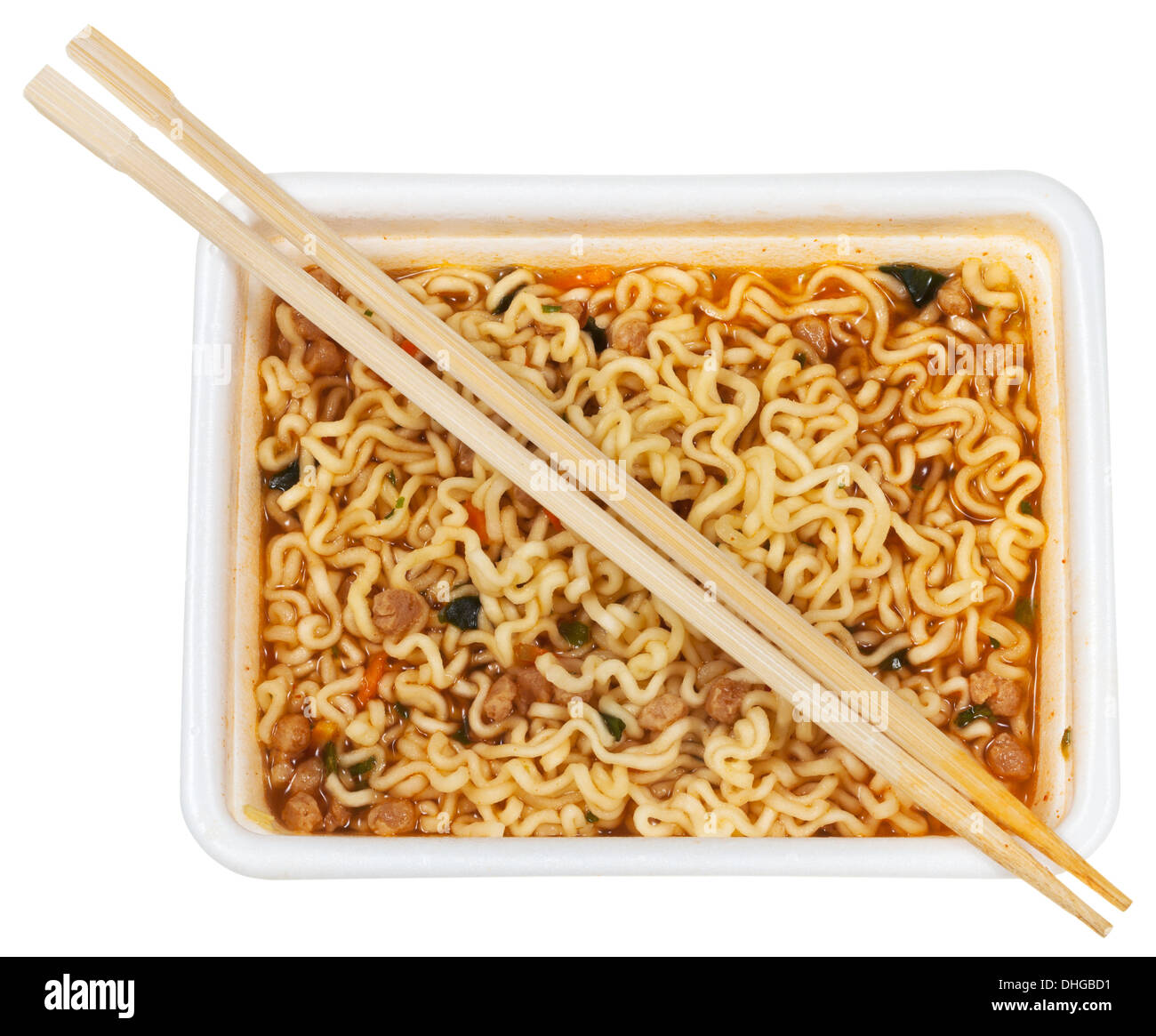 top view of cooked instant ramen and wooden chopsticks in foam cap isolated on white background Stock Photo
