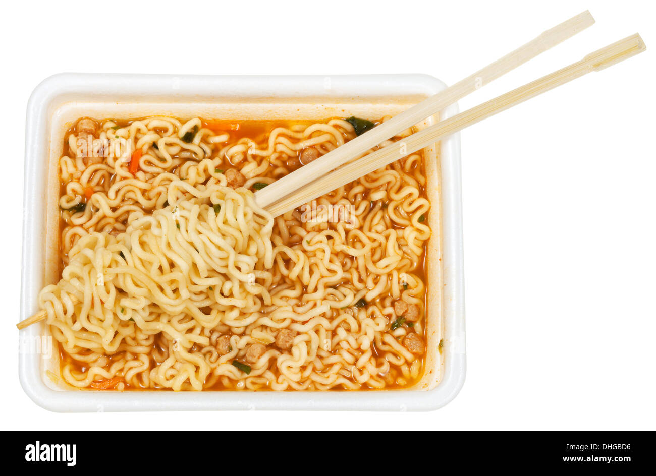 eating of prepared instant ramen by wooden chopsticks from foam cap isolated on white background Stock Photo