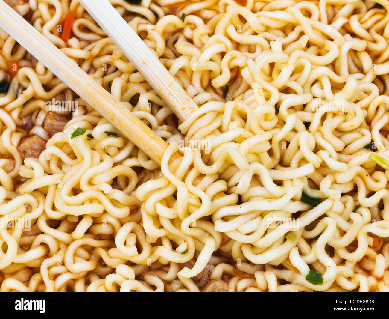 eating of cooked instant noodles by wooden chopsticks close up Stock Photo