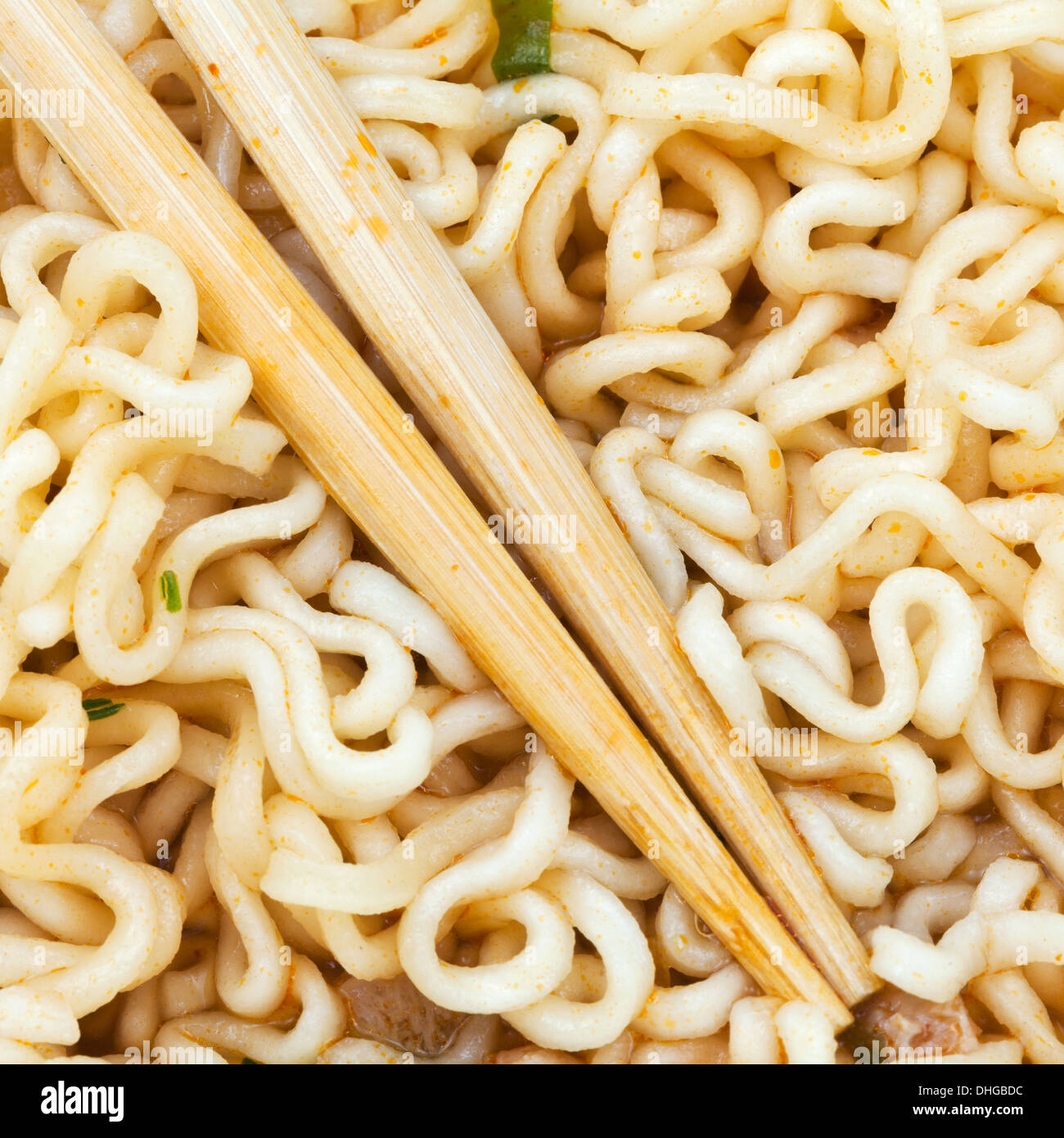 eating of cooked instant ramen by wooden chopsticks close up Stock Photo
