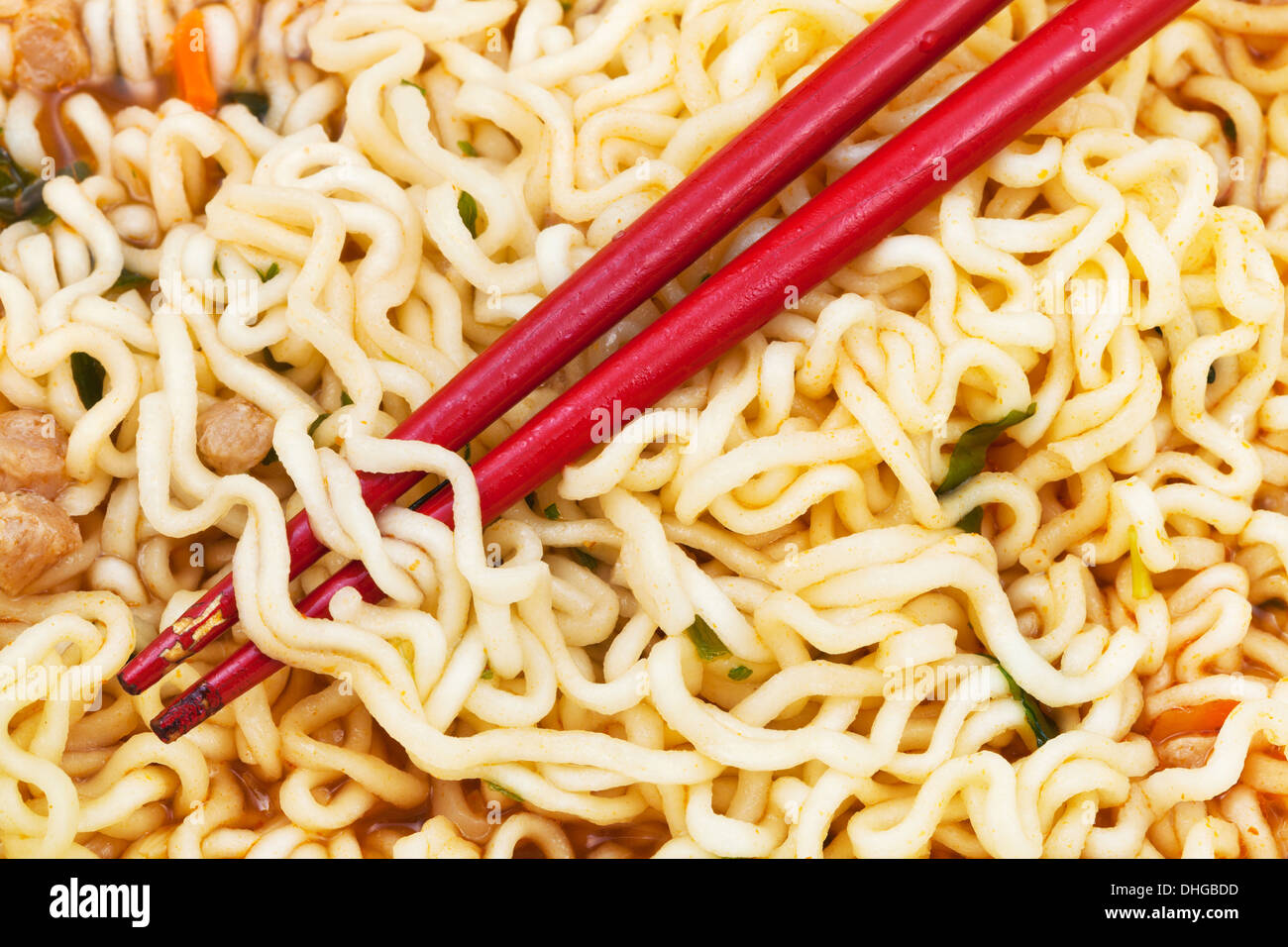red chopsticks on cooked instant ramen close up Stock Photo