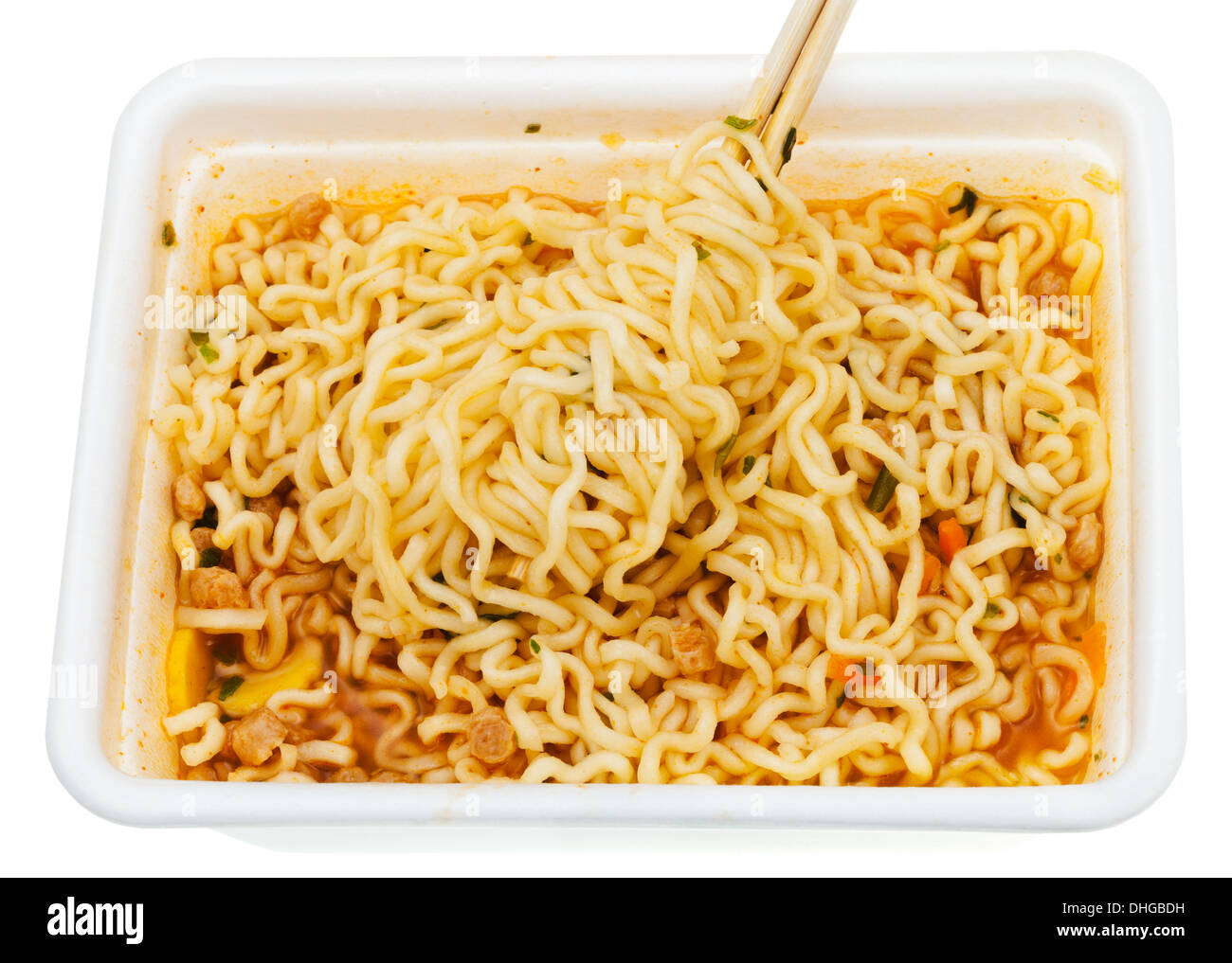 eating of instant noodles by wooden chopsticks from lunch box isolated on white background Stock Photo