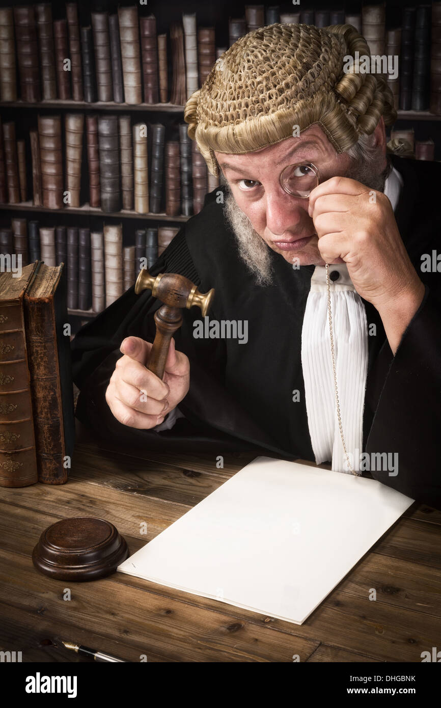 Funny judge looking through an antique monocle Stock Photo
