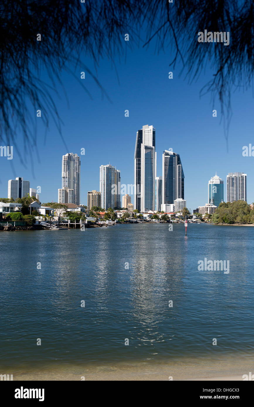 Beach on the Nerang River looking toward Gold Coast high rise apartment buildings. Stock Photo