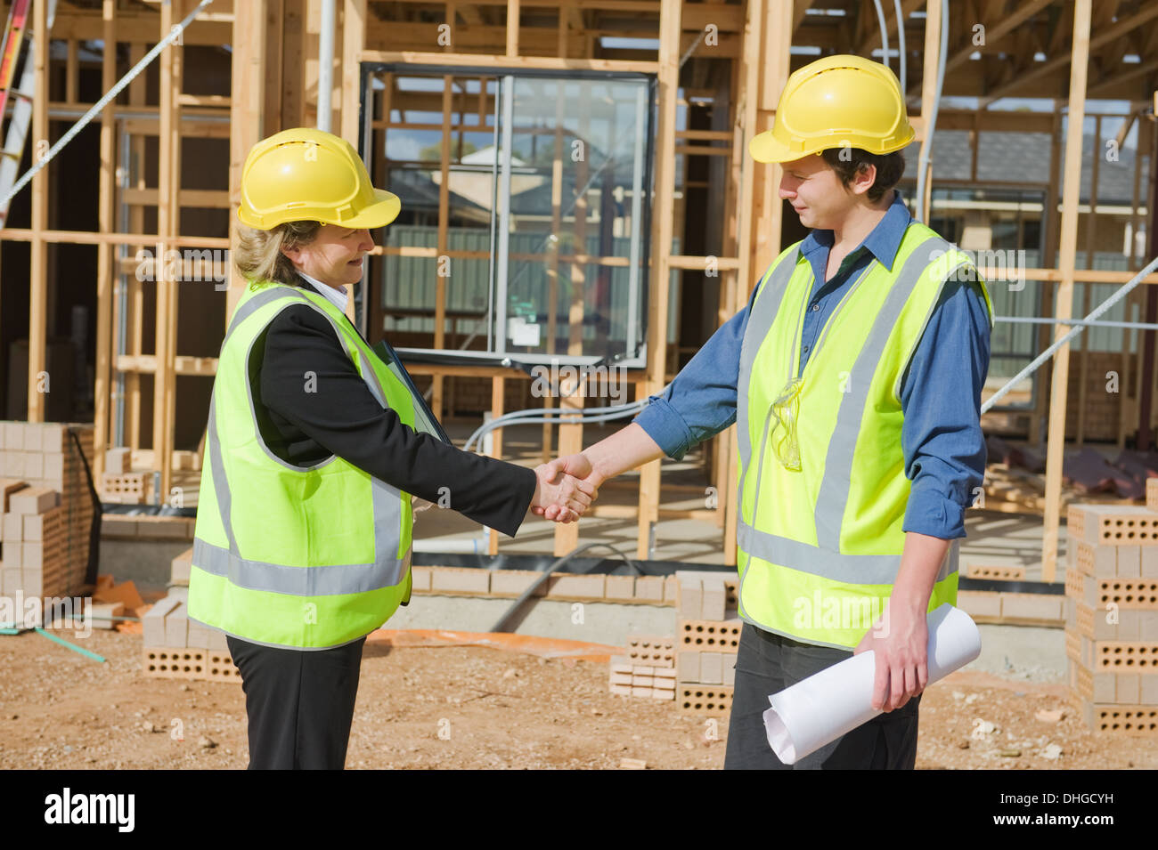 civil engineer and worker shaking hands at the construction site Stock Photo