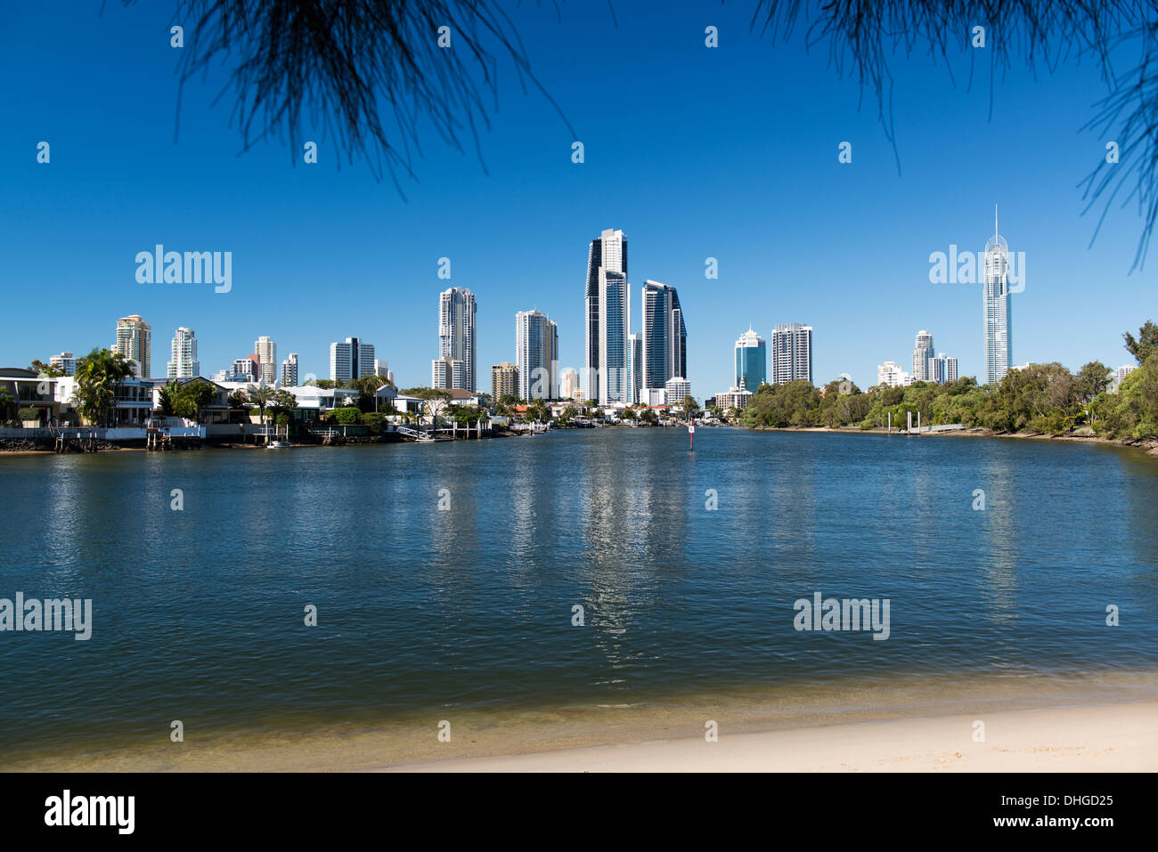 Beach on the Nerang River looking toward Gold Coast high rise apartment buildings, including Q1. Stock Photo