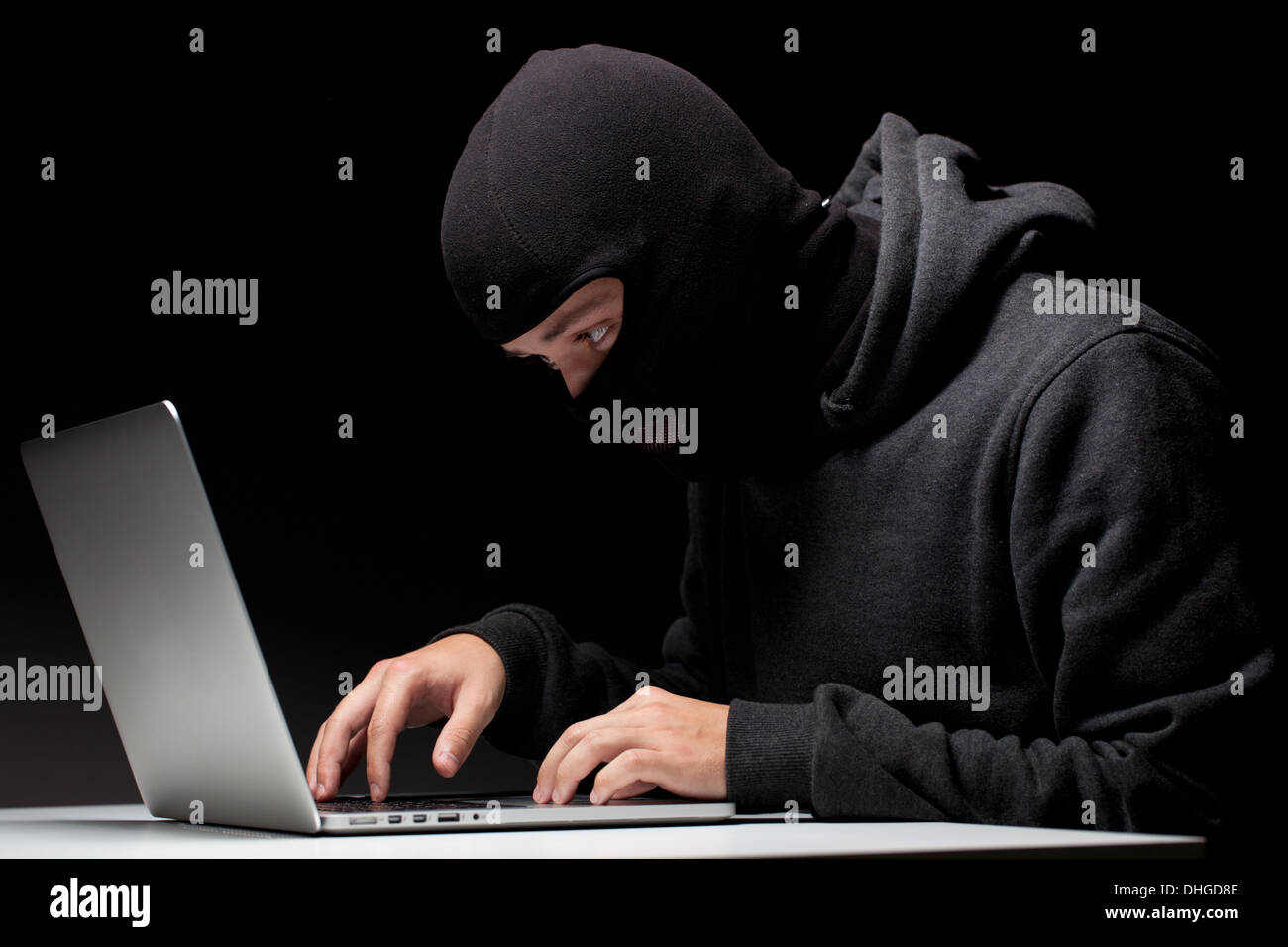 Computer hacker in a balaclava Stock Photo