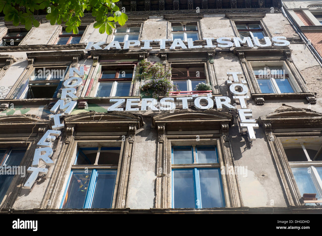 Squat in Prenzlauer Berg with anti-capitalist message on front of building Berlin Germany Stock Photo