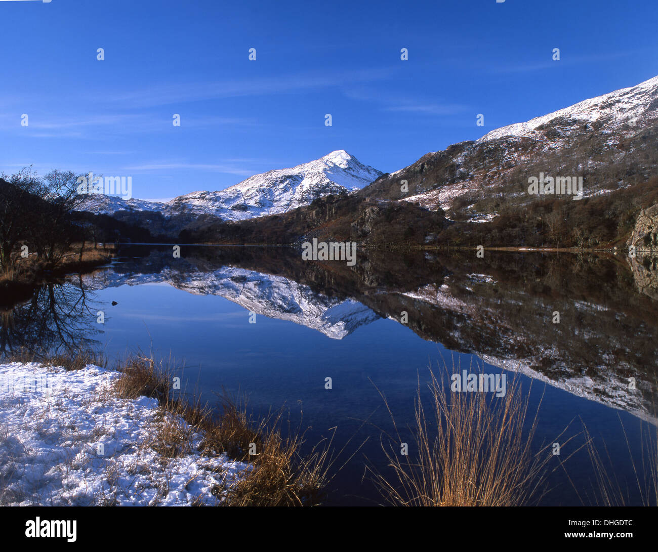 Yr Aran reflected in Llyn Gwynant in snow Snowdonia National Park Gwynedd North Wales UK Stock Photo