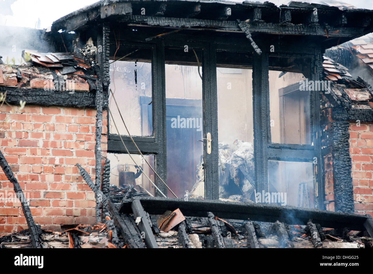 Dormer window house on fire charred burnt smoke Stock Photo