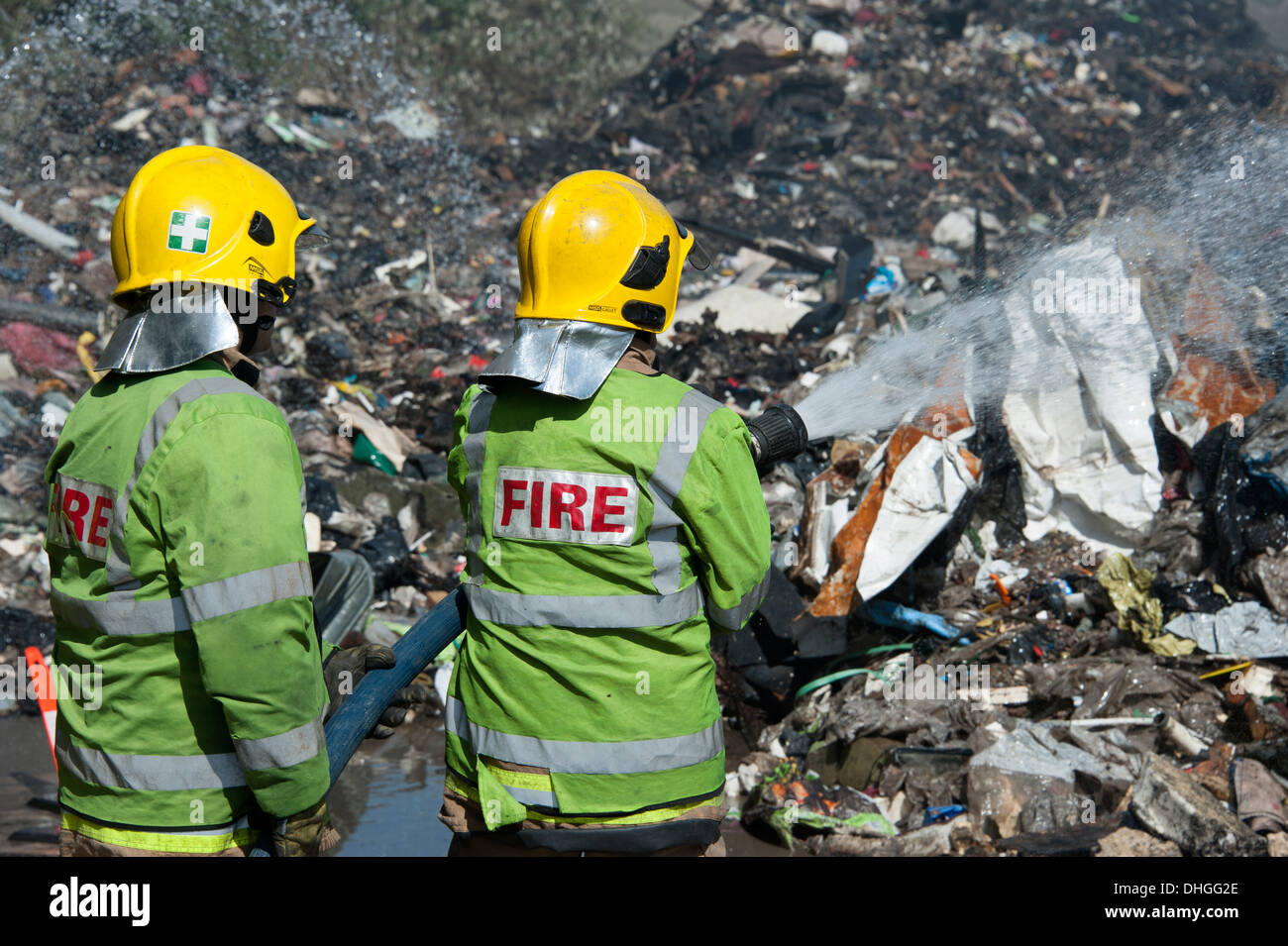 Firefighters Firemen fighting rubbish fire Stock Photo