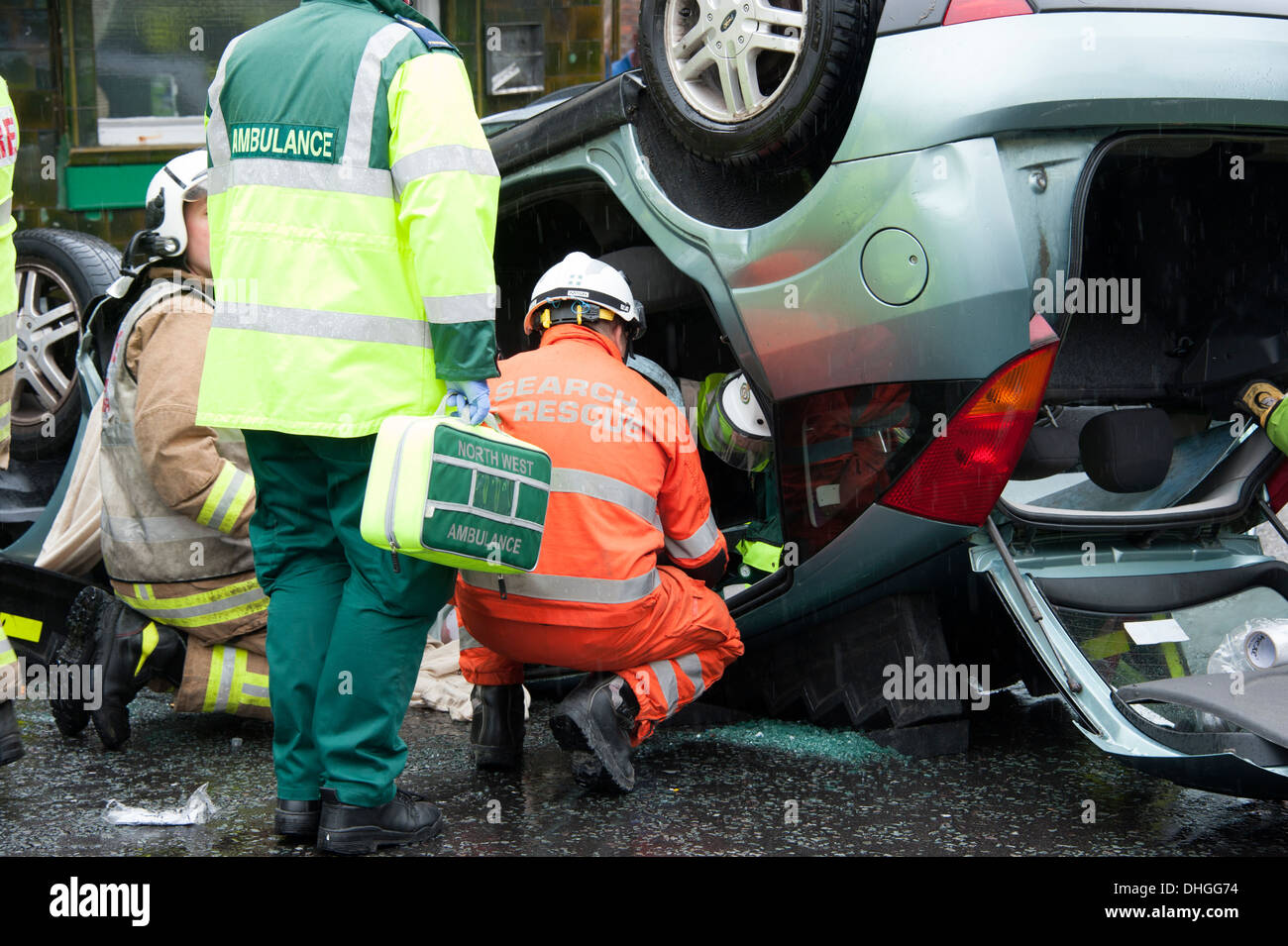 Car Crash overturned on roof rescue Fire Cut extricate Stock Photo - Alamy