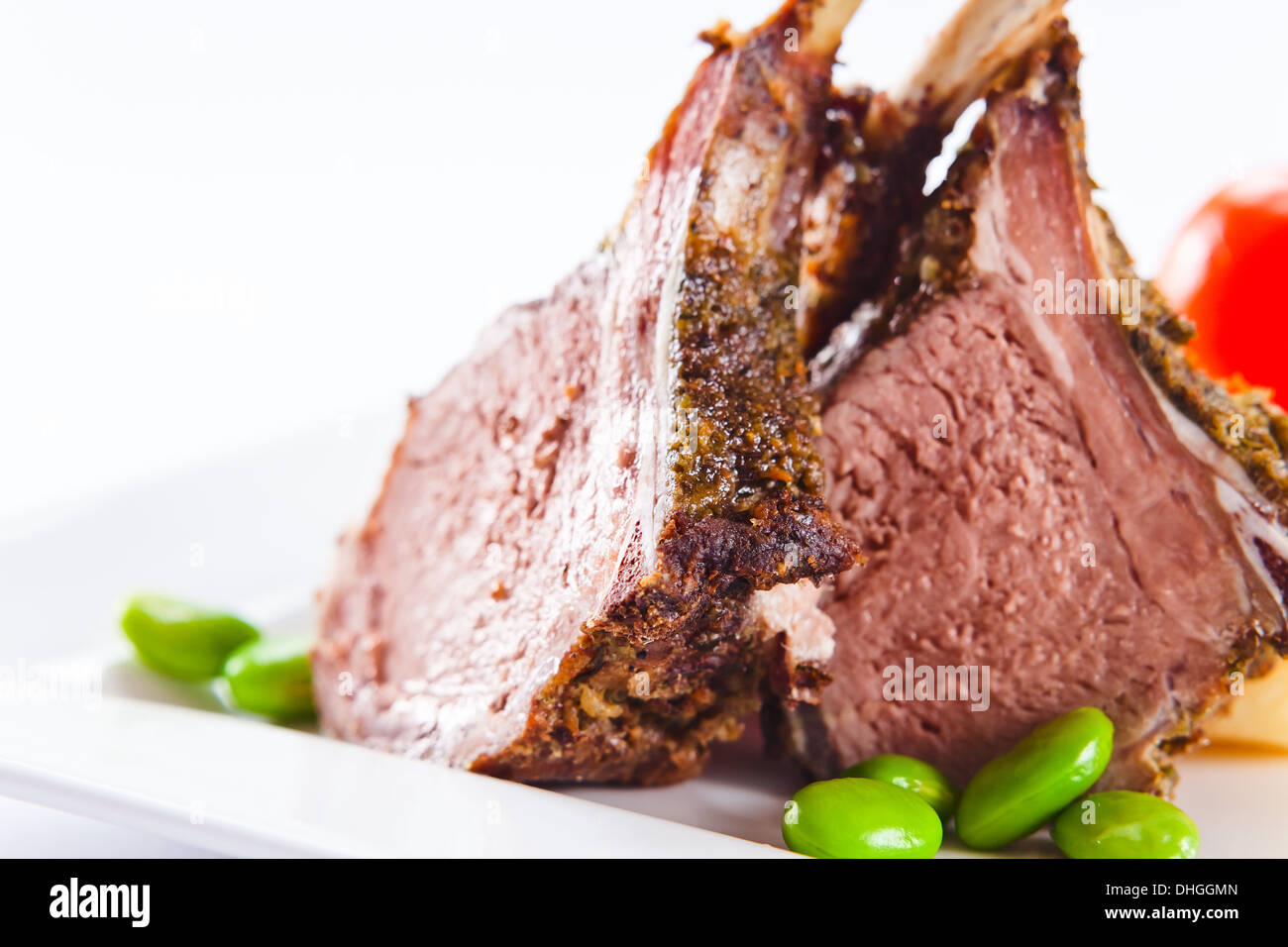 Stewed mutton with green string bean on a white plate Stock Photo
