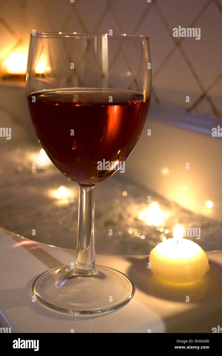 Relaxing romantic bubble bath with a glass of wine. Stock Photo