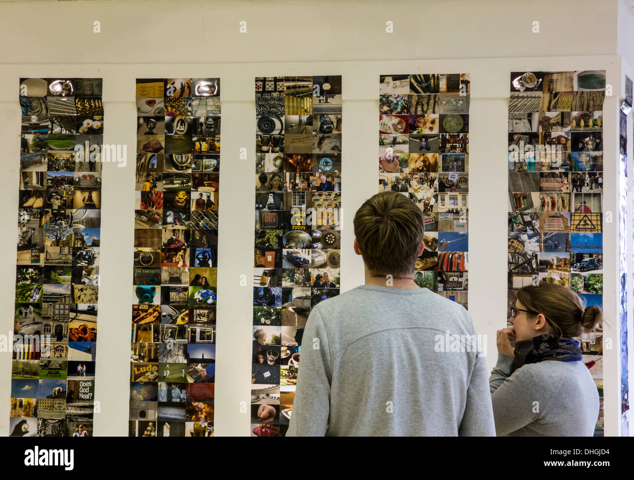 Young couple looking at photographs at an art exhibition, Bath ...