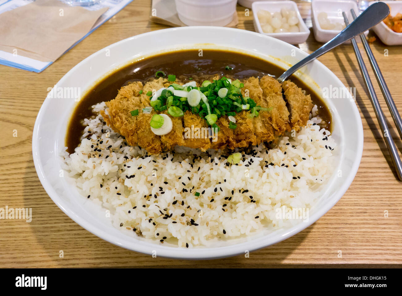 Katsu Karē is a Japanese dish comprising curry and rice served with a breaded pork cutlet on top. Stock Photo
