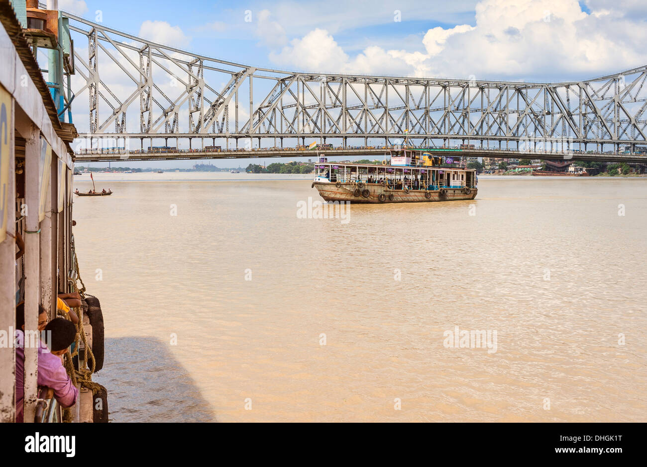 Public ferries ply the Hoogly river with the old Howrah bridge in the background in Kolkata, India. Stock Photo