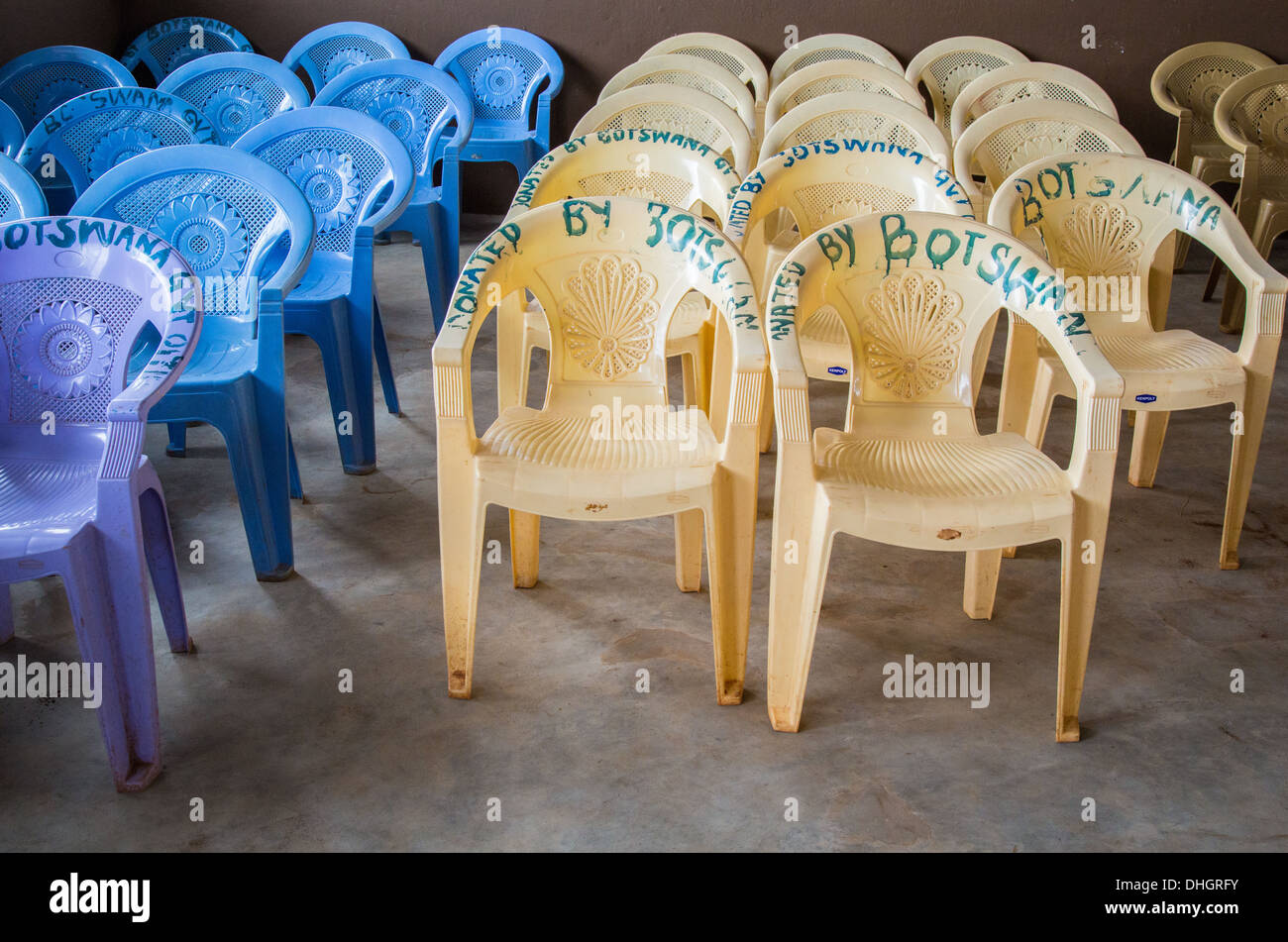 Plastic garden chairs donated by Botswana in a Kenyan primary school hall Stock Photo