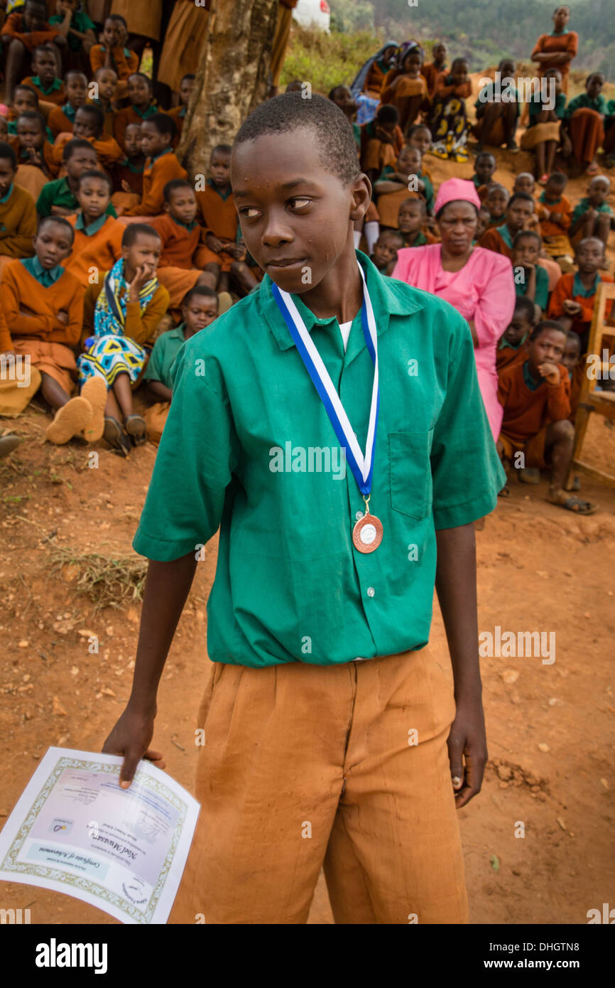 Schoolboy with medal and certificate of achievement in a Kenyan Primary school in the Sagalla Hills near Voi Africa Stock Photo