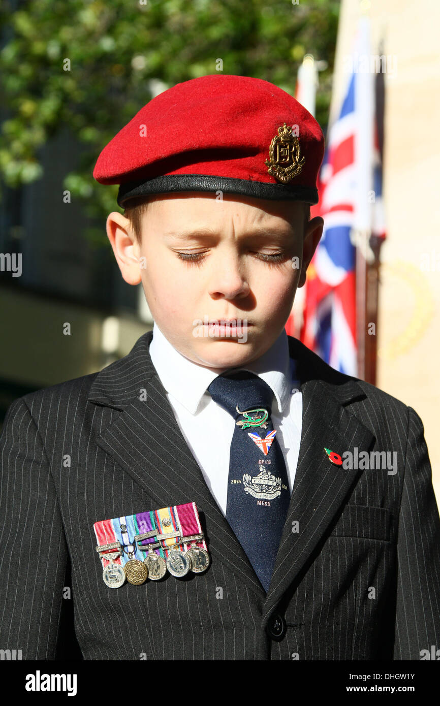 Remembrance Sunday . . Peterborough, Cambridgeshire, UK . . 10.11.2013 Haidan Blades (10), wearing his grandads war medals, including a British Empire with bar, takes a moment to reflect by the War Memorial on Remembrance Sunday in Peterborough, Cambridgeshire. Pic: Paul Marriott Photography Stock Photo