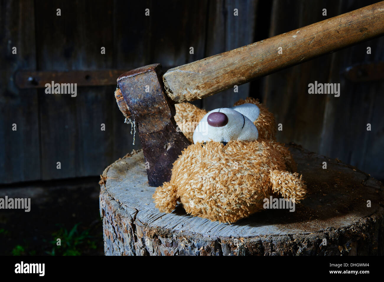 Execution of child toy teddy bear with an ax Stock Photo