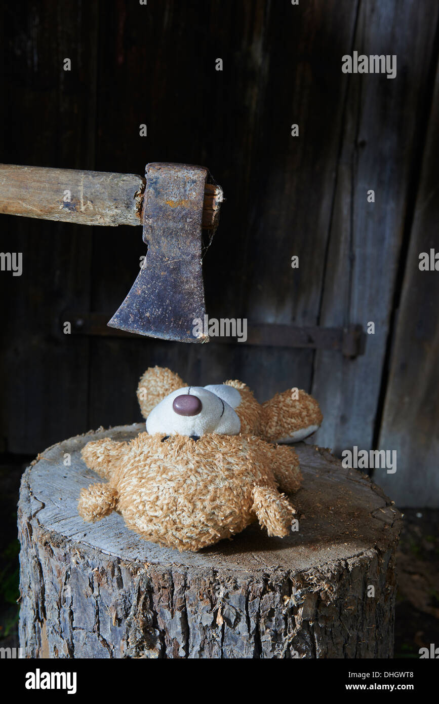 Execution - murder of child toy teddy bear with an ax Stock Photo