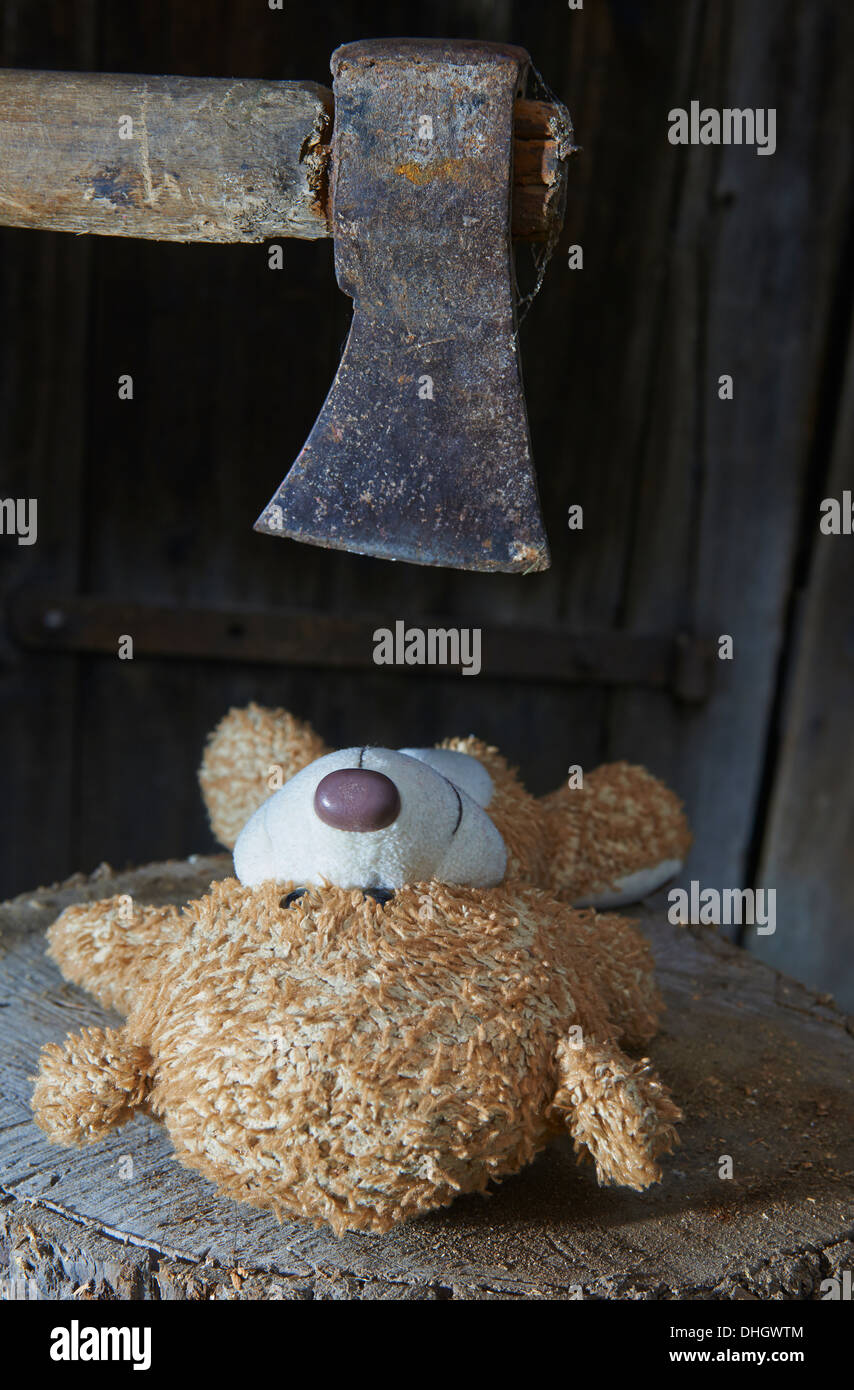 Execution of child toy teddy bear with an ax Stock Photo