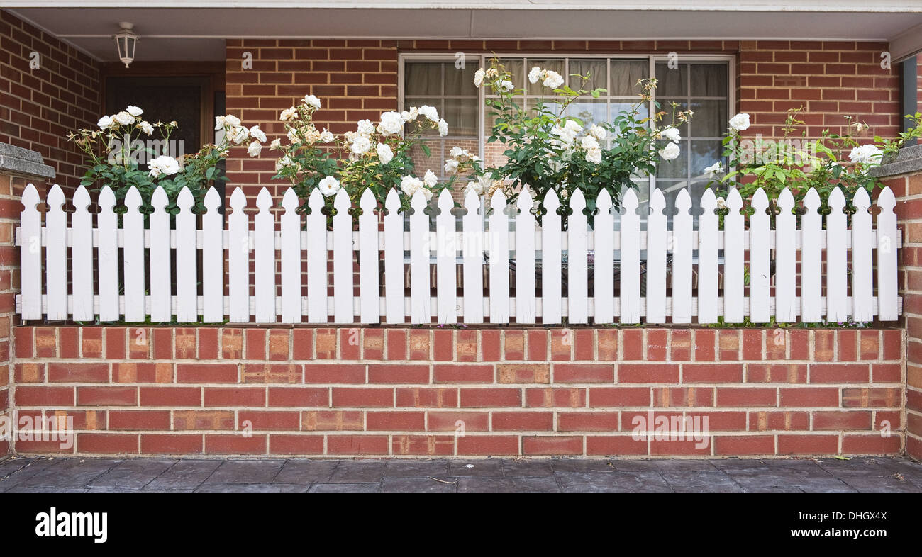 beautiful house entrance with white fence and small front yard Stock Photo
