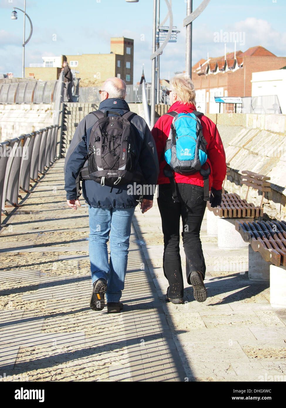 A senior man and lady walking along the hot walls in old Portsmouth, England Stock Photo
