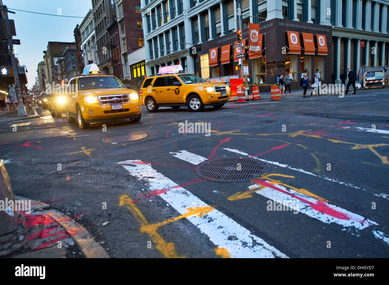 New York yellow taxis passing an intersection in Soho area Stock Photo