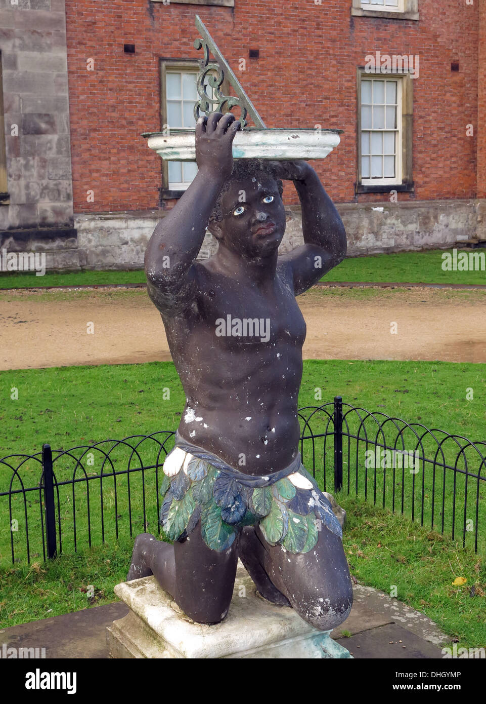 Black African holding sundial at Dunham Massey Hall , near Altrincham Cheshire England , UK WA14 4SJ, BLM, Black Statue, Do Black Lives Matter Stock Photo