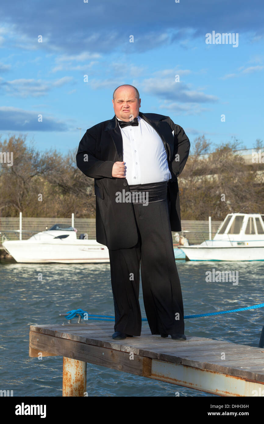 Fat man in tuxedo on pier Stock Photo Alamy