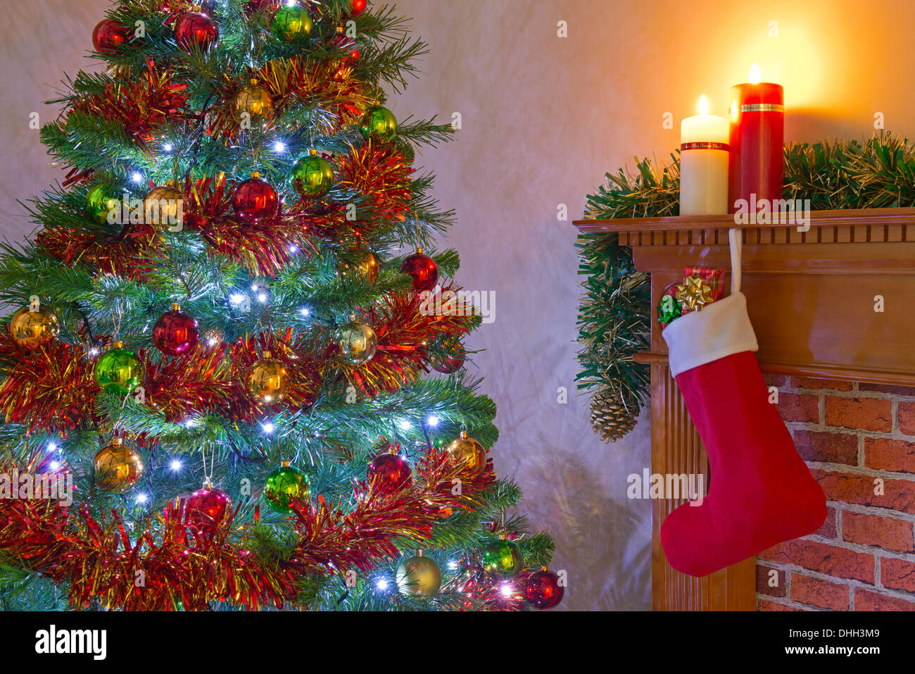 Christmas Eve with presents in a stocking hanging over the fireplace on the mantlepiece Stock Photo