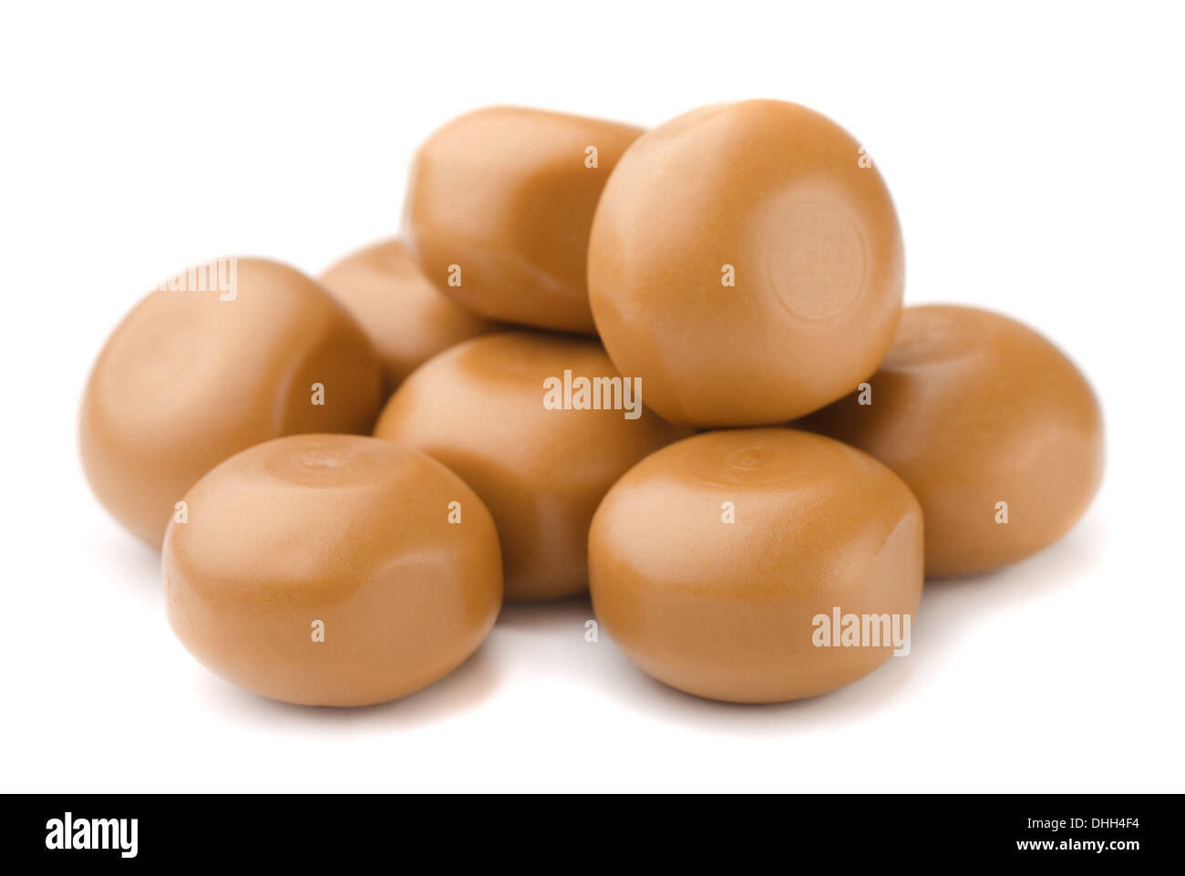 Stack of milk caramel candies isolated on white Stock Photo